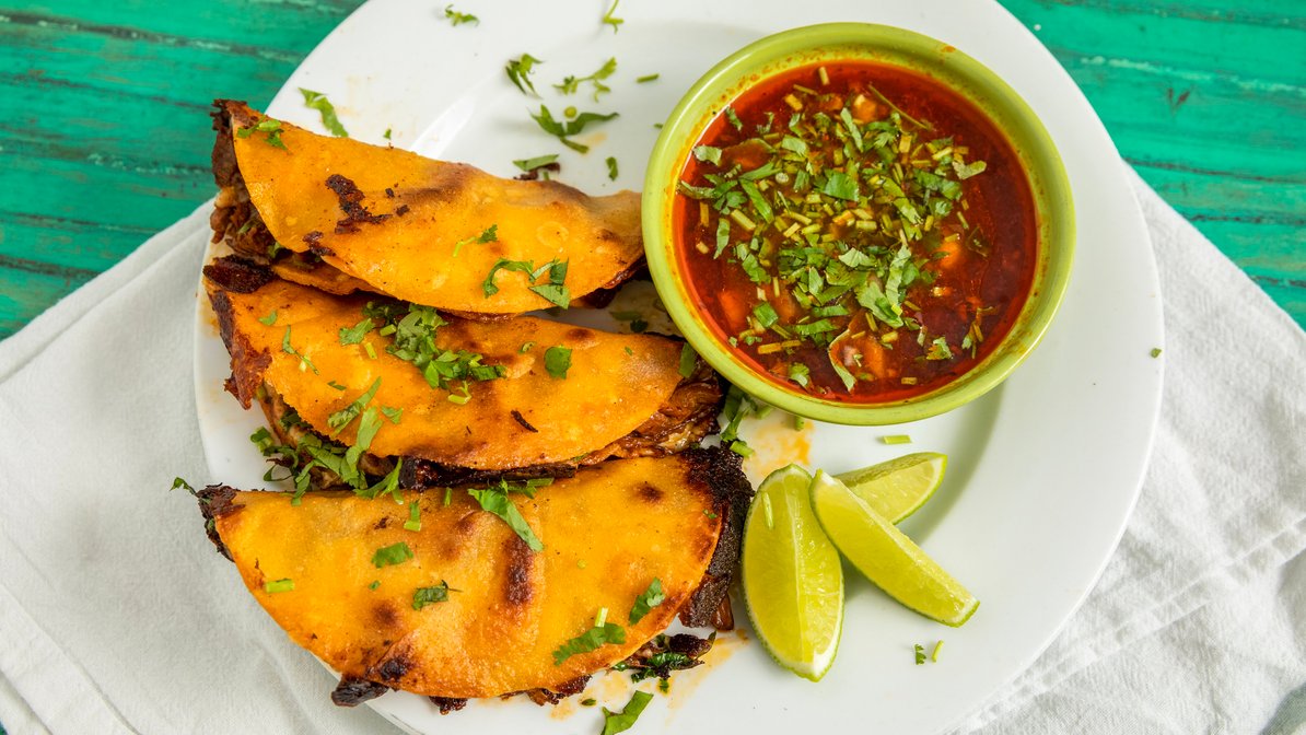 Tacos loaded with grilled meat, onion and cilantro